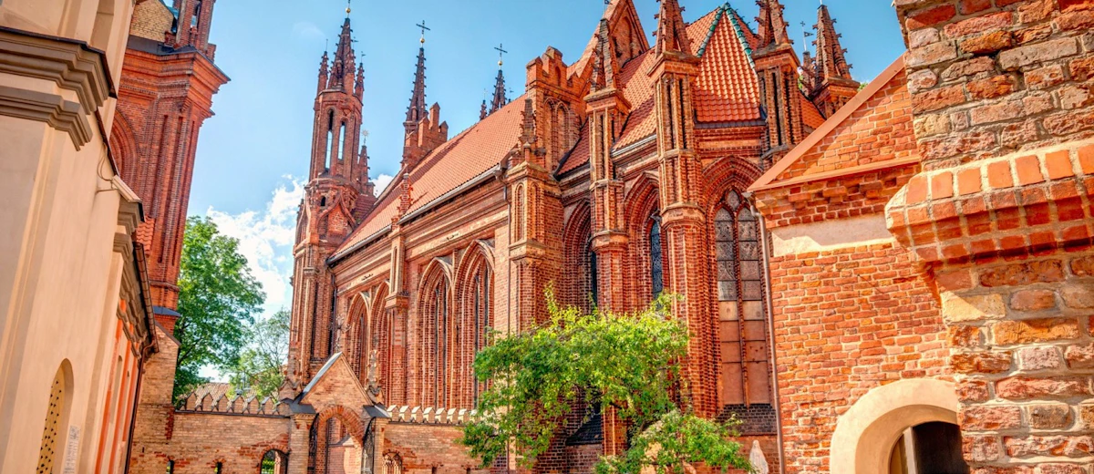 Historic Vilnius architecture and red-brick Gothic details—perfect for a folklore-themed walk through the Old Town