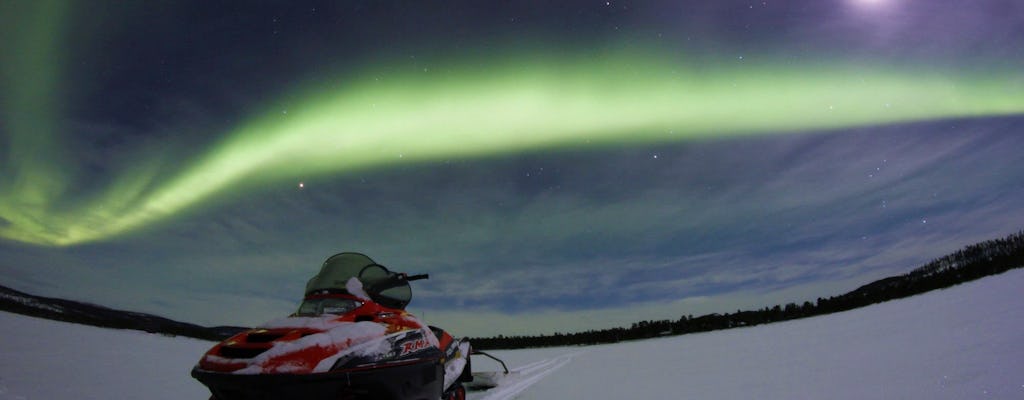 Northern lights hunt by snowmobile