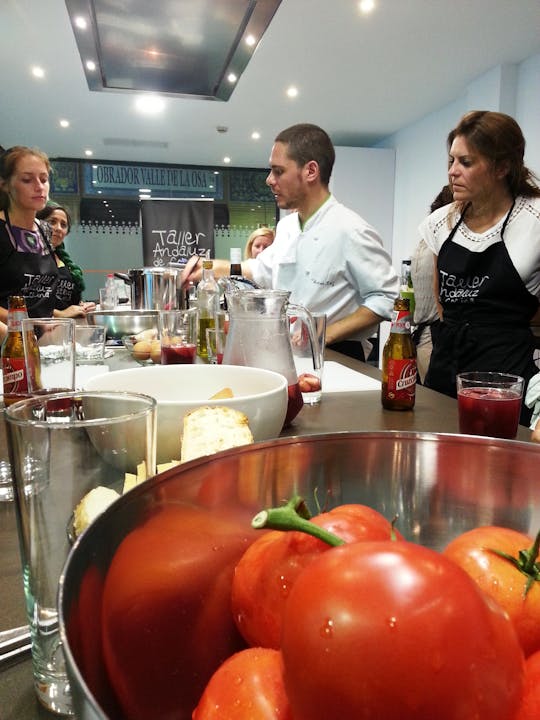 Paella cooking class and dinner inside the Triana market