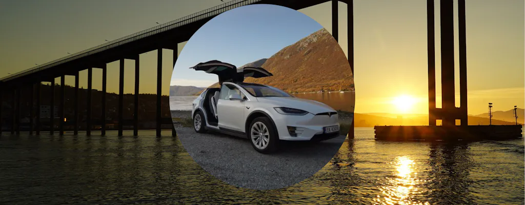 Tesla Model X parked in Arctic landscape at midnight sun time near Tromsø