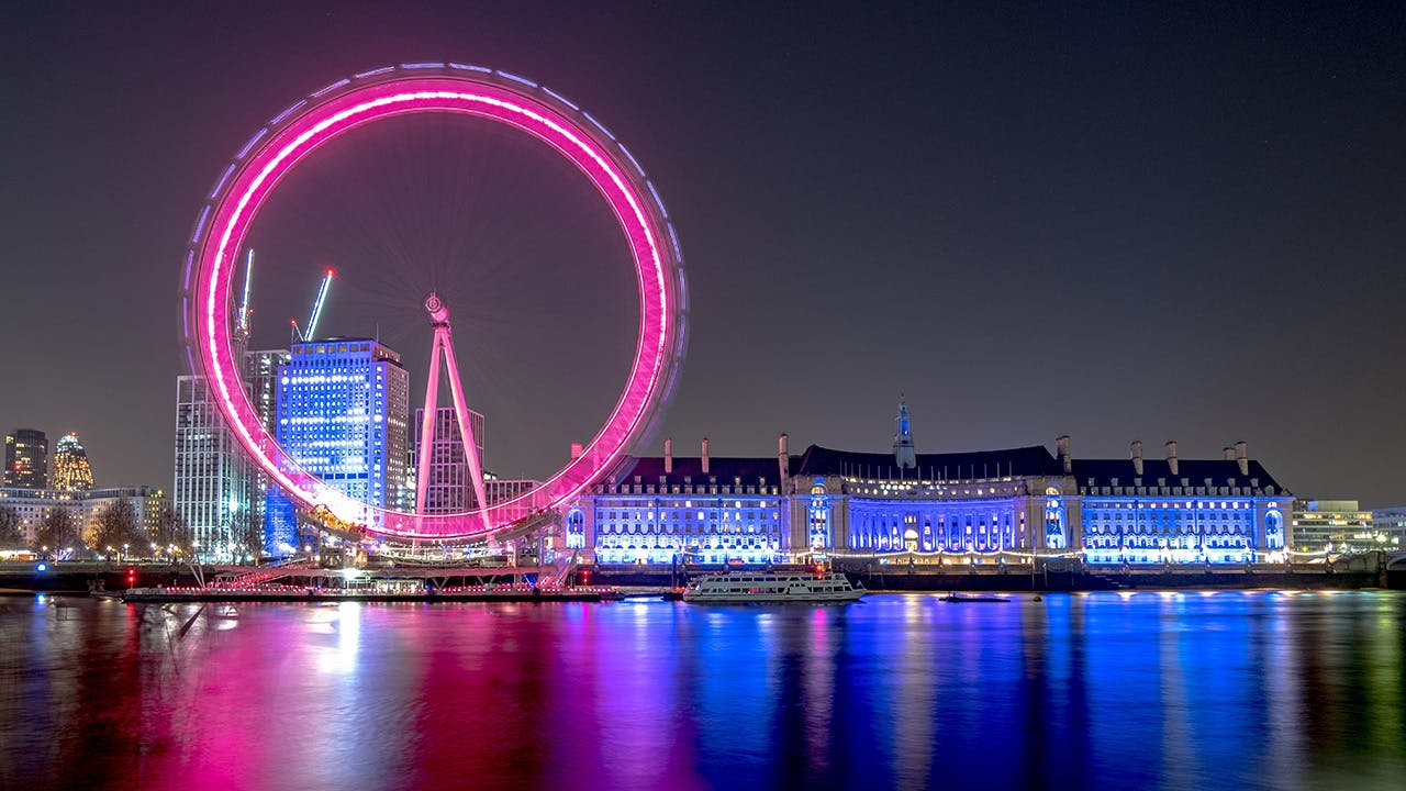 London Eye and Thames bank illuminated at night.jpg