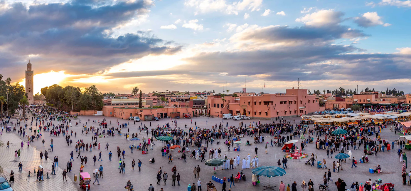 Panoramic view of Marrakech with Jemaa el-Fna square and city rooftops at sunset