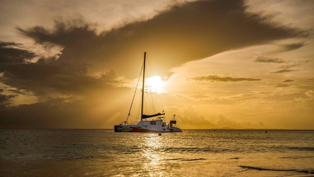 Picturesque Spanish Water Irie catamaran sailing experience at sunset