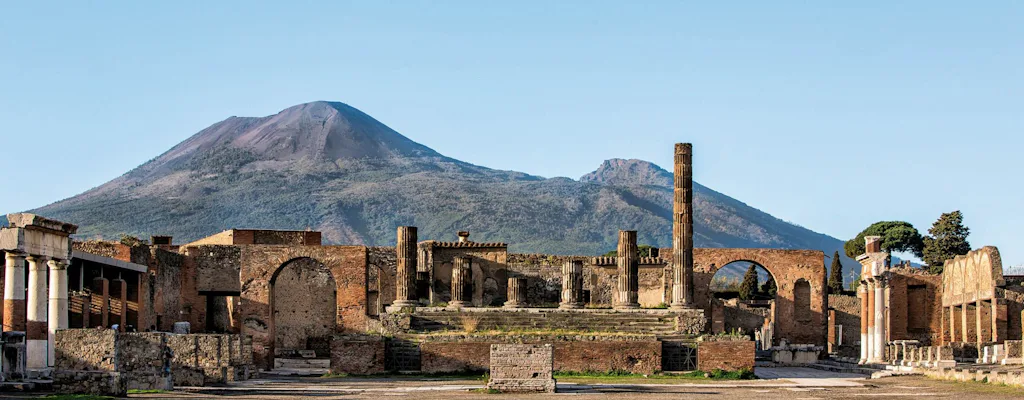 Pompeii ruins with Mount Vesuvius behind them on a small group tour from Maiori