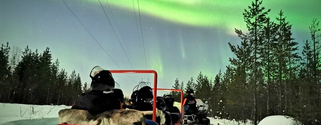 Northern lights sledge ride by snowmobile