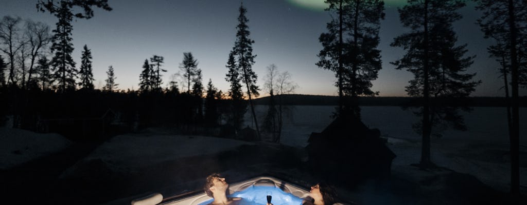 Arctic forest sauna and hot tub experience with northern lights