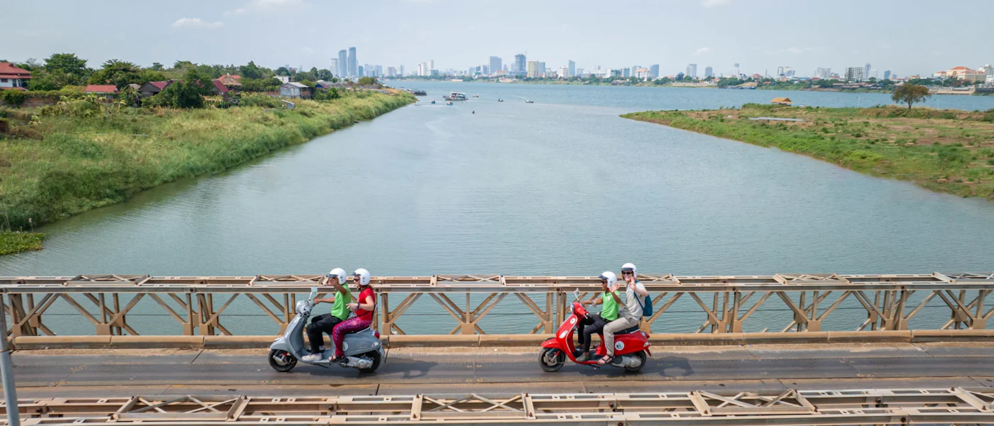 Riders on Vespas crossing a bridge near Phnom Penh on the way to Silk Island (Koh Dach)
