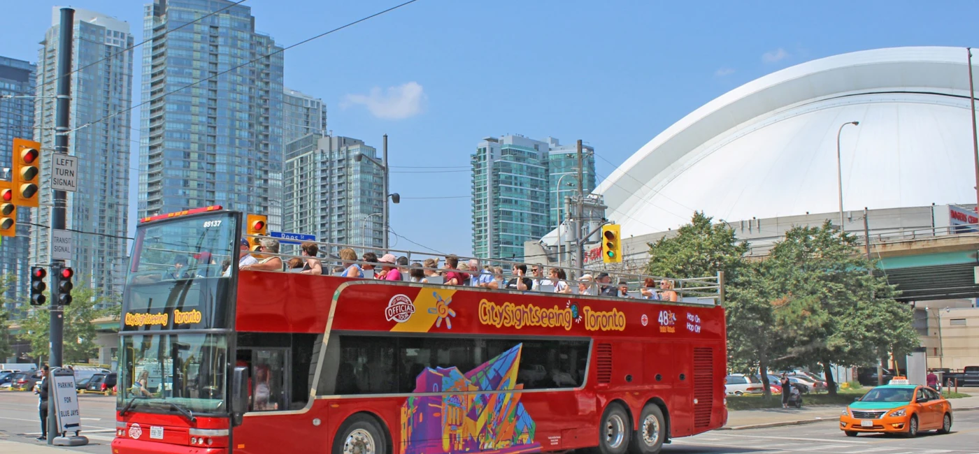 Red double-decker hop-on hop-off sightseeing bus in downtown Toronto