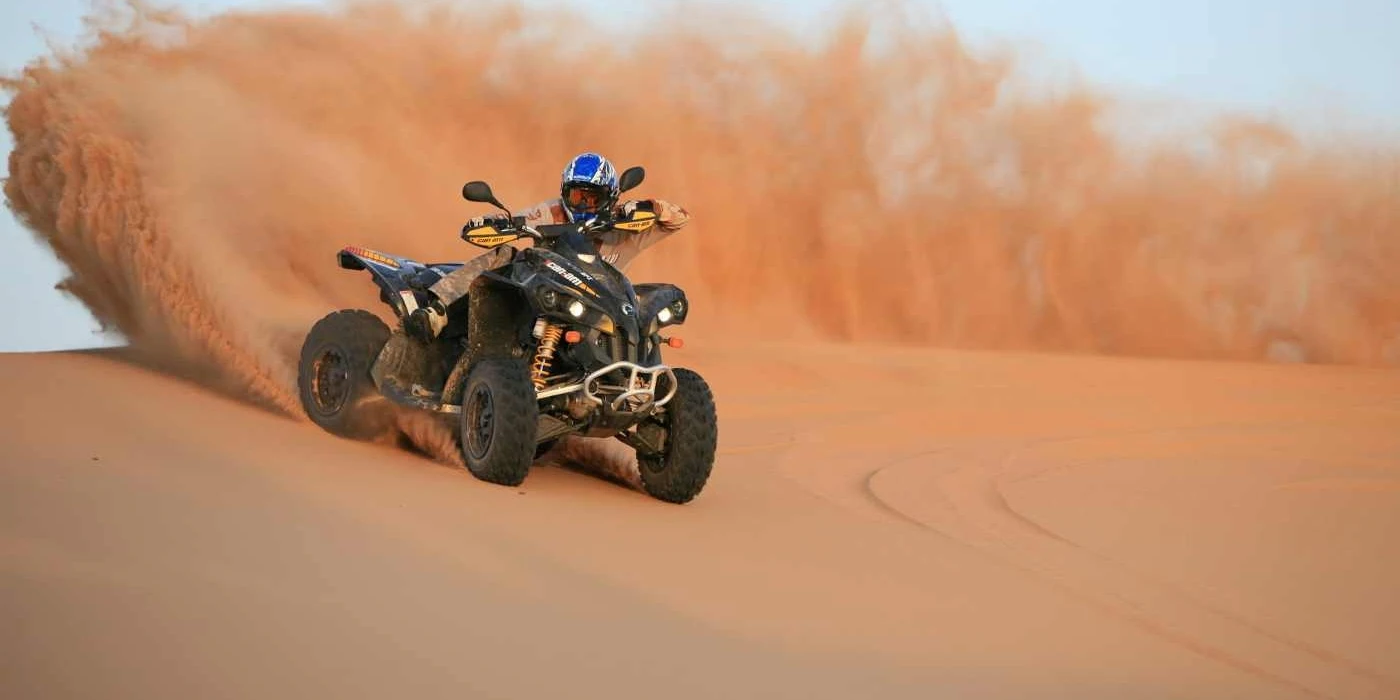 Quad bike riding across desert dunes near El-Alamein on Egypt’s north coast
