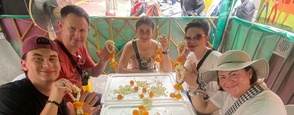 Travellers making traditional Thai jasmine and marigold garlands during a floral workshop in Bangkok