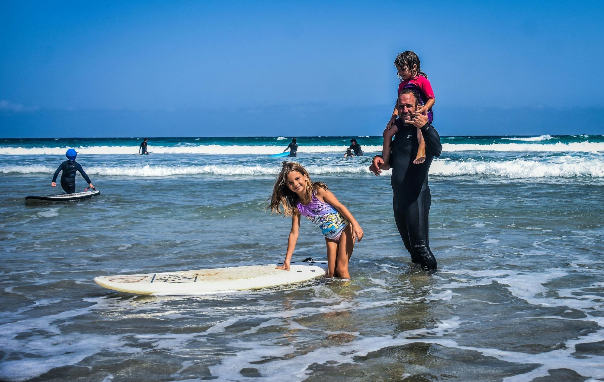 Family surfing session in the south of Fuerteventura