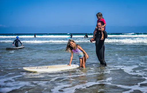 Family surfing session in the south of Fuerteventura
