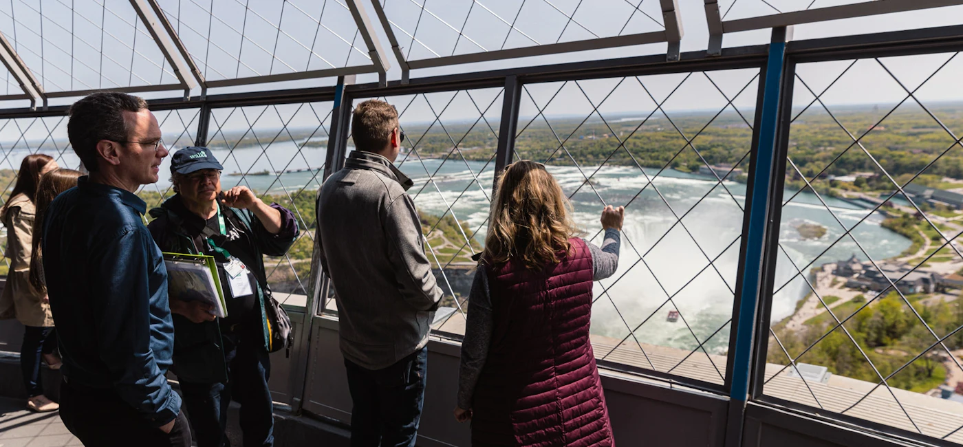 Visitors looking out from the Skylon Tower observation area over Niagara Falls