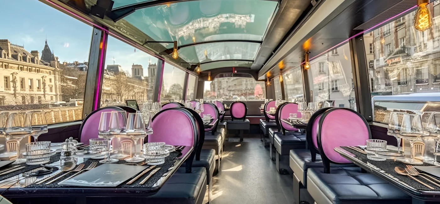 Dining tables inside a panoramic sightseeing bus in Paris with large windows