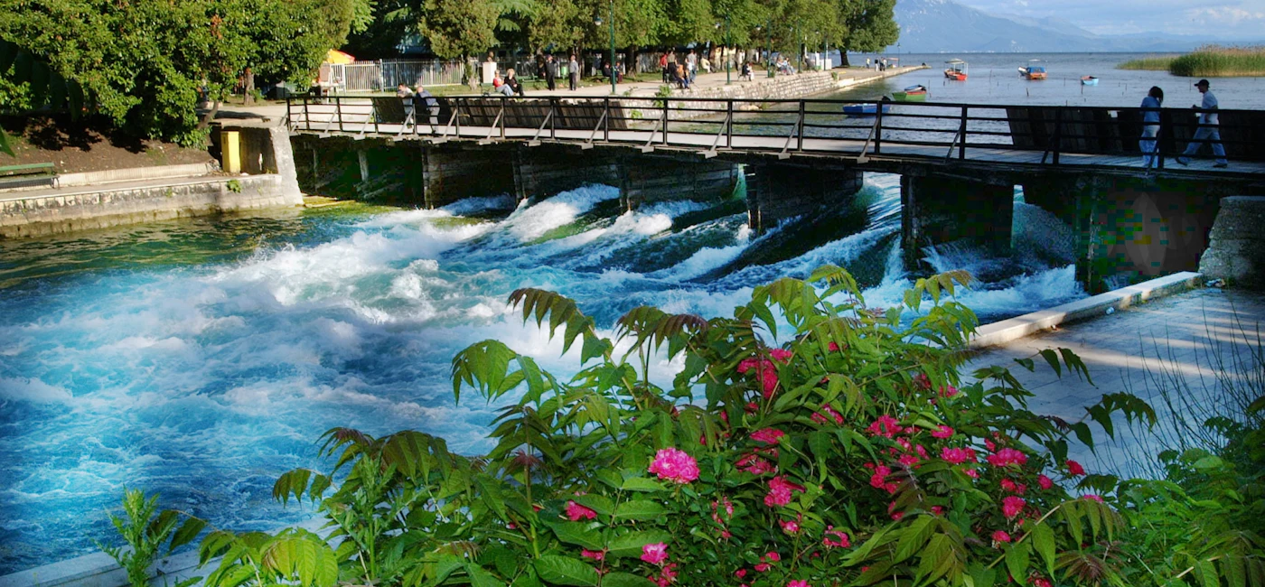 Riverside scene in Struga where Lake Ohrid flows into the Black Drim River on a day tour from Ohrid