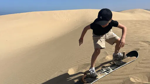 Half-day camel ride and sandboarding adventure