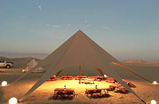 Huacachina desert glamping experience with dinner and sandboarding