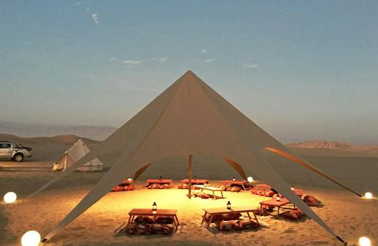 Huacachina desert glamping experience with dinner and sandboarding