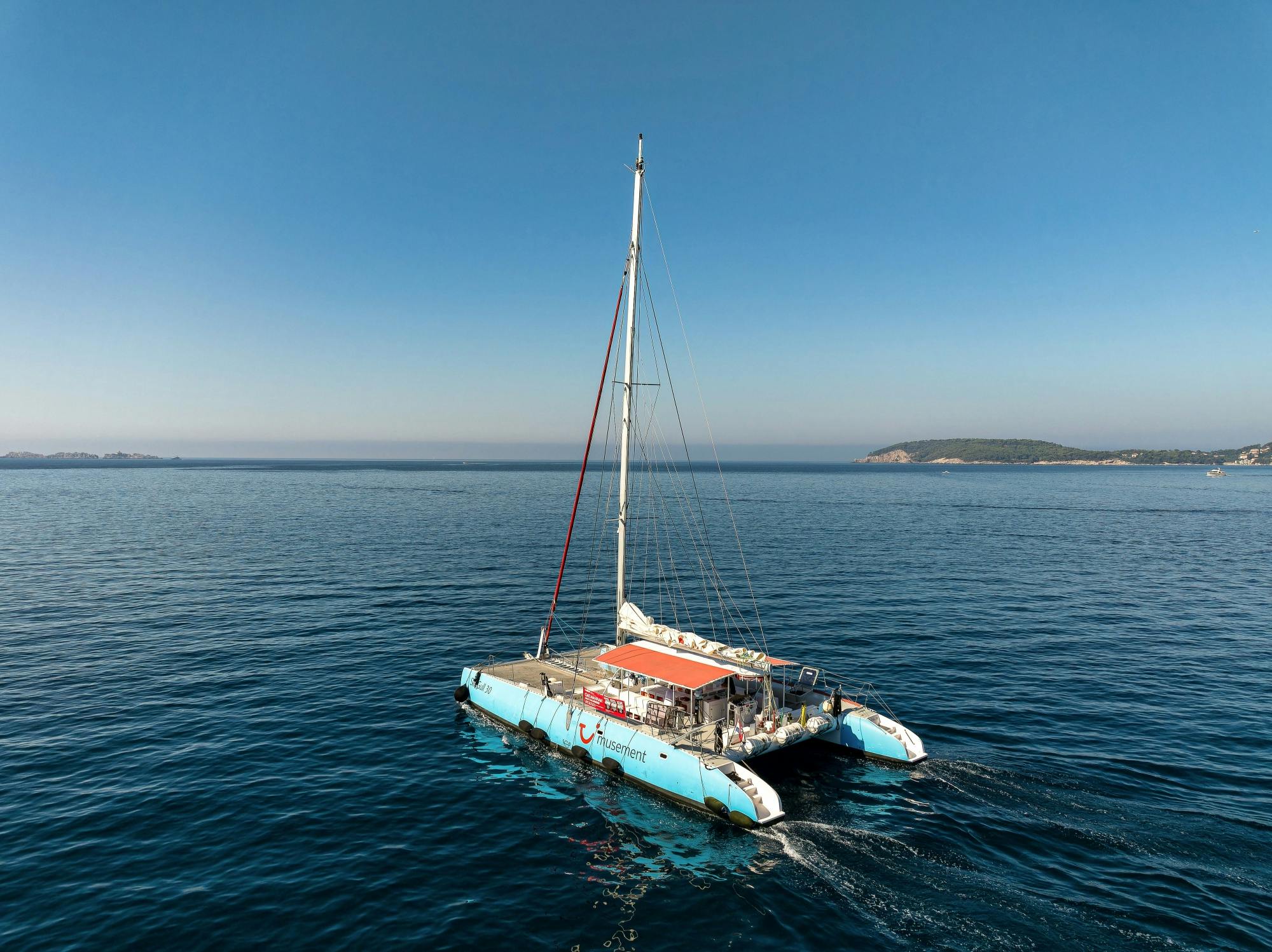 Corfu east coast catamaran cruise with drinks, snacks and optional transfers