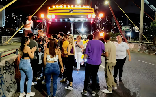 Medellín night tour on an open-air party bus with bar stop