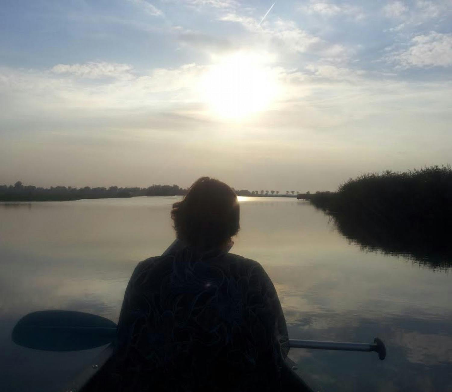 wetlands sunset woman paddling to sun.jpg