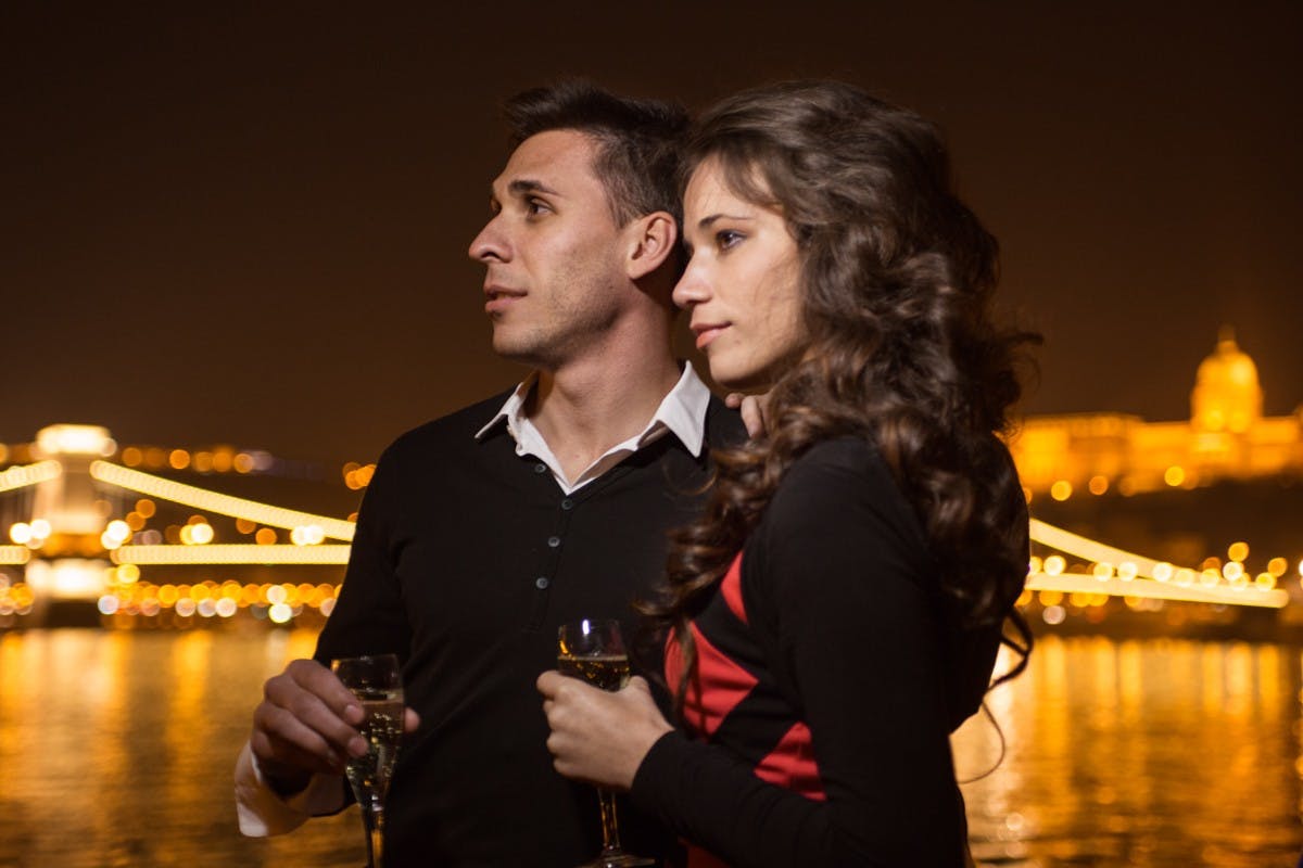 Budapest late night dinner cruise couple looking at river.jpg