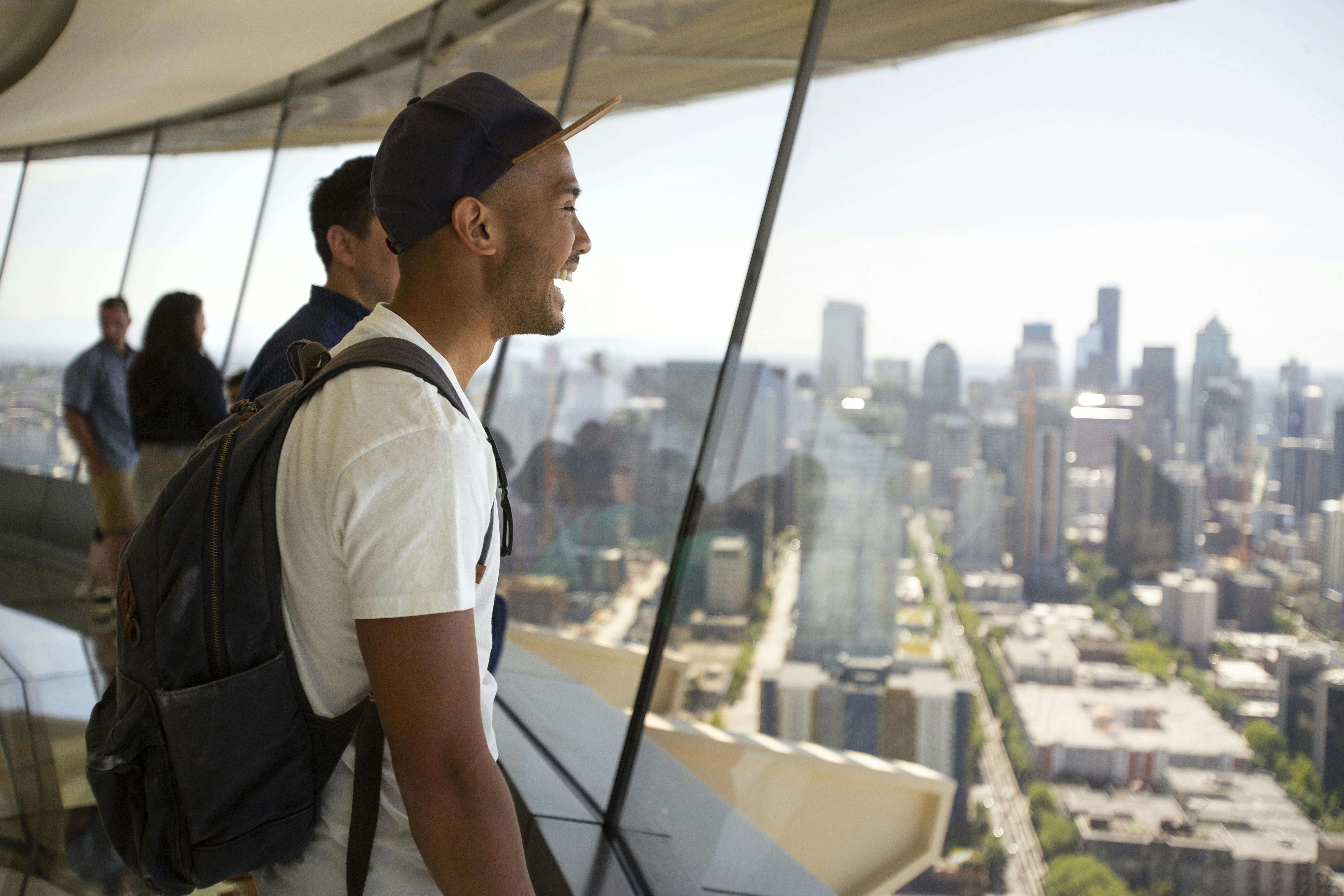 Guest enjoys views of downtown Seattle from the Space Needle glass floor - The Loupe.jpg