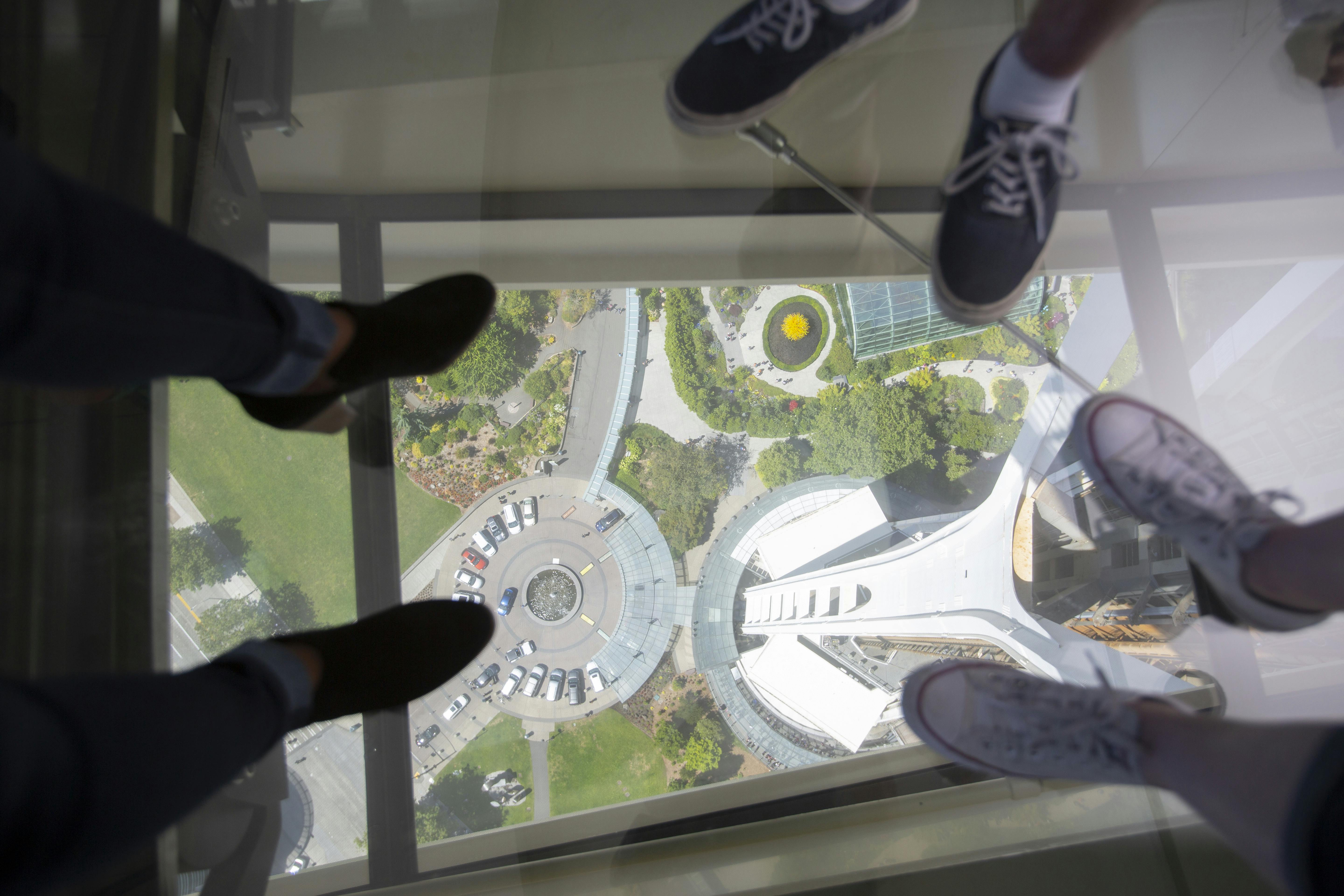 Guests step out onto The Loupe - Space Needle revolving glass floor. Courtesy of John Lok and Space Needle LLC.jpg