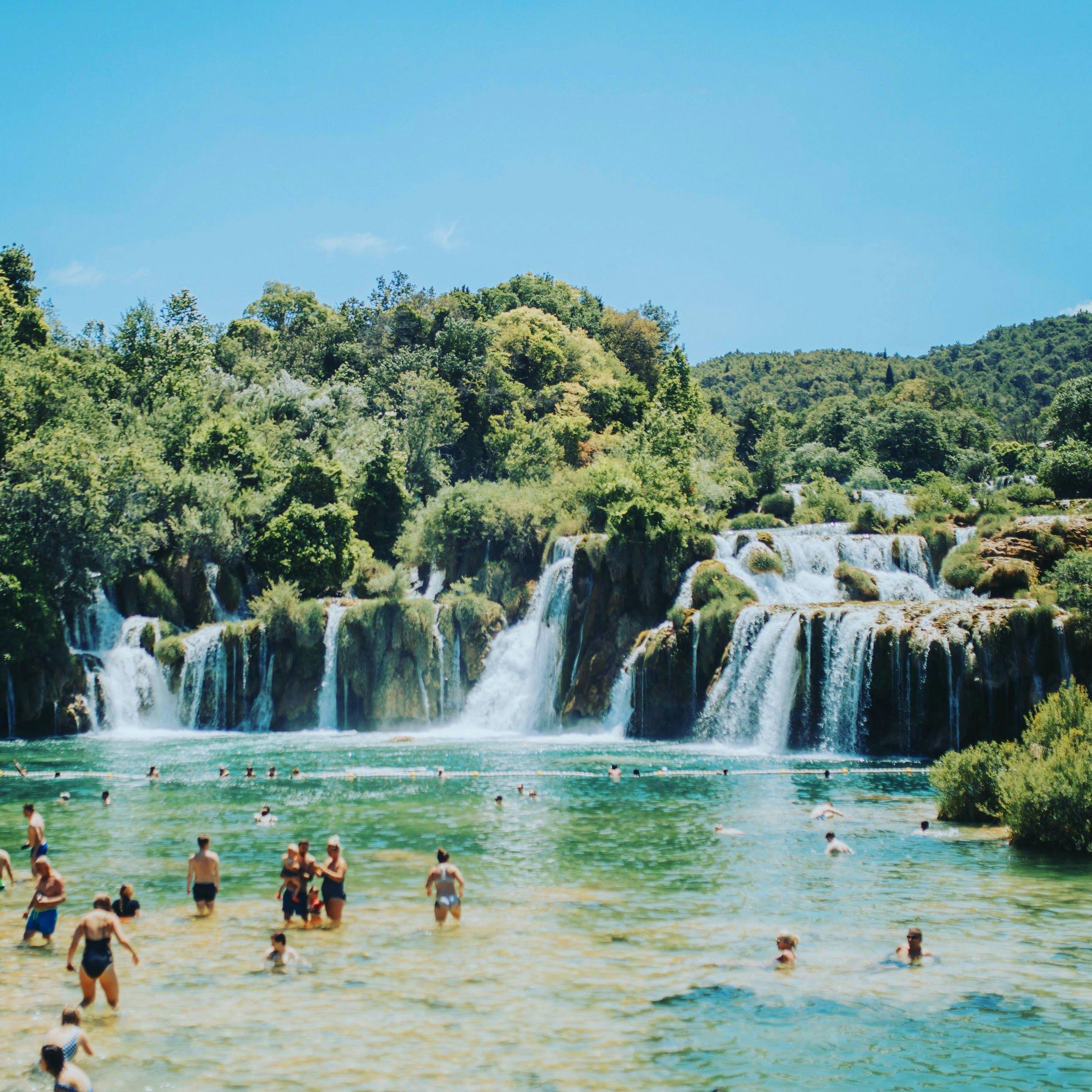 Krka waterfall with people swimming.jpeg