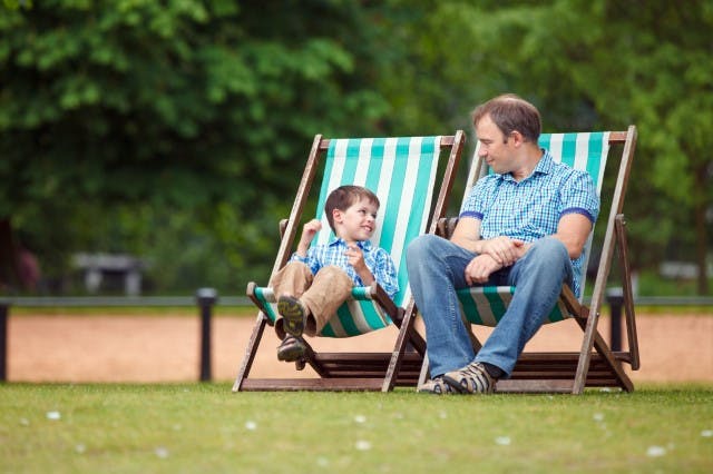 Kid and dad sitting on a chair.jpg